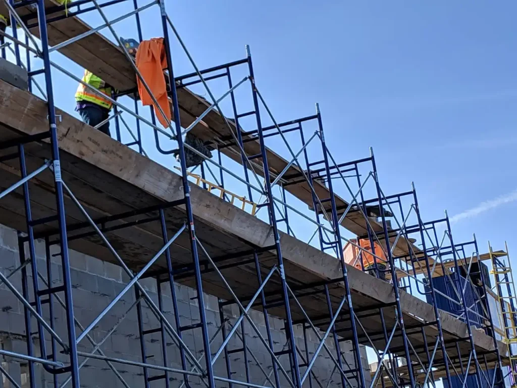 West Covina Scaffolding Rental frame scaffolding with workers on a commercial construction project