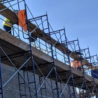 West Covina Scaffolding Rental frame scaffolding with workers on a commercial construction project